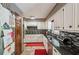 Traditional style kitchen with white cabinets, mosaic backsplash, and black countertops at 8540 Ridge Rd, Fairburn, GA 30213