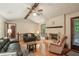 Comfortable living area with hardwood floors, exposed beams, a brick fireplace, and outdoor access at 8540 Ridge Rd, Fairburn, GA 30213