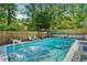 Outdoor backyard pool with seating, perfect for relaxation and summertime enjoyment at 8540 Ridge Rd, Fairburn, GA 30213