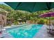 Lush backyard pool with seating areas and mature landscaping at 8540 Ridge Rd, Fairburn, GA 30213