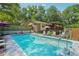 Large backyard in-ground pool with a deck, perfect for summer fun and outdoor enjoyment at 8540 Ridge Rd, Fairburn, GA 30213