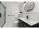 This bathroom features modern fixtures, an updated shower, and a decorative circular mirror at 2965 Pharr Court South Nw # 304, Atlanta, GA 30305