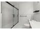 This bathroom features an updated shower and modern white marble-styled tile at 2965 Pharr Court South Nw # 304, Atlanta, GA 30305