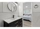 The bathroom features a modern vanity, a round mirror, and tile accents at 2965 Pharr Court South Nw # 304, Atlanta, GA 30305