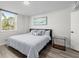 This bedroom features natural lighting, a modern gray decor, and light hardwood floors at 2965 Pharr Court South Nw # 304, Atlanta, GA 30305