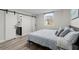 This bedroom features a modern slider door, light hardwood floors, and a relaxing gray decor at 2965 Pharr Court South Nw # 304, Atlanta, GA 30305