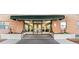 Building entrance with brick facade, awning, stairs, and glass doors at 2965 Pharr Court South Nw # 304, Atlanta, GA 30305
