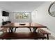 Modern dining area featuring a wooden table, bench seating, and light-filled window views at 2965 Pharr Court South Nw # 304, Atlanta, GA 30305