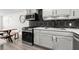 Updated kitchen features stainless appliances, white countertops and a black hexagon backsplash at 2965 Pharr Court South Nw # 304, Atlanta, GA 30305
