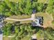 Aerial view showcasing the property's layout, driveway, surrounding trees, and ample land at 3070 Glad Dale Se Dr, Conyers, GA 30094