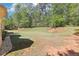 Expansive backyard featuring a large lawn and mature trees, perfect for outdoor activities at 3070 Glad Dale Se Dr, Conyers, GA 30094