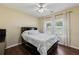 This bedroom includes hardwood floors, 2 large windows, and a ceiling fan at 3070 Glad Dale Se Dr, Conyers, GA 30094