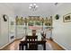 Well lit dining room boasts natural light and views of the landscaped yard through the large window at 3070 Glad Dale Se Dr, Conyers, GA 30094