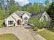 Beautiful home featuring a well-manicured lawn, stone accents, and a paved driveway at 3070 Glad Dale Se Dr, Conyers, GA 30094