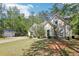 Beautiful home with a well-manicured lawn, lush greenery, and a separate garage at 3070 Glad Dale Se Dr, Conyers, GA 30094