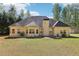Rear exterior view of a tan home with a dark roof, showing multiple windows and a chimney at 3070 Glad Dale Se Dr, Conyers, GA 30094