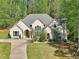 Charming home with a lush green lawn, complemented by mature trees and a welcoming driveway at 3070 Glad Dale Se Dr, Conyers, GA 30094