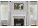 Cozy fireplace with a decorative mantle and hearth, flanked by windows with sheer curtains at 3070 Glad Dale Se Dr, Conyers, GA 30094