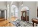 Grand foyer featuring hardwood floors, a decorative front door, and archways leading to other rooms at 3070 Glad Dale Se Dr, Conyers, GA 30094