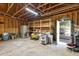 Spacious garage featuring exposed beams, shelving units, and a workbench area at 3070 Glad Dale Se Dr, Conyers, GA 30094