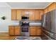 Kitchen featuring stainless steel appliances, light wood cabinets, and tile backsplash at 3070 Glad Dale Se Dr, Conyers, GA 30094