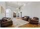 Open-concept living room with hardwood floors, high ceilings, and a view of the foyer at 3070 Glad Dale Se Dr, Conyers, GA 30094