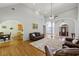 Open-concept living room with hardwood floors, high ceilings, and a view of the foyer and kitchen at 3070 Glad Dale Se Dr, Conyers, GA 30094