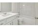 Bright bathroom features a marble tile shower surround and white vanity at 5816 Creek Indian Dr, Sugar Hill, GA 30518