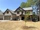 Attractive two-story home with a brick exterior, a two-car garage, gabled roof, and an inviting front entrance at 5816 Creek Indian Dr, Sugar Hill, GA 30518