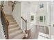 Grand foyer with hardwood floors, staircase with iron railings, and a view to the living spaces at 5816 Creek Indian Dr, Sugar Hill, GA 30518