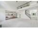 Bright and airy living room with an upstairs balcony view and an open-concept layout to the kitchen at 5816 Creek Indian Dr, Sugar Hill, GA 30518