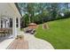 Backyard patio includes outdoor seating, a dining table, and covered porch overlooking a lawn at 110 White Oak Trl, Cumming, GA 30028