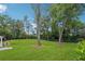 Large, well-maintained backyard with mature trees and a black fence border at 110 White Oak Trl, Cumming, GA 30028