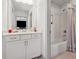 Bathroom showcasing a modern vanity with marble countertop and a bathtub with white subway tile at 110 White Oak Trl, Cumming, GA 30028