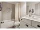 Bathroom with a tub-shower, a white vanity, and tiled walls at 110 White Oak Trl, Cumming, GA 30028