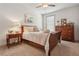 Comfortable bedroom featuring a wooden bed frame, ceiling fan, and an ample amount of natural light at 110 White Oak Trl, Cumming, GA 30028