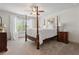 Spacious bedroom featuring a four-poster bed, bedside tables, and a large window at 110 White Oak Trl, Cumming, GA 30028
