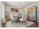 Elegant dining room with a chandelier, wainscoting, and decorative hutch, perfect for entertaining at 110 White Oak Trl, Cumming, GA 30028
