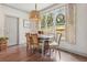 Bright dining room with hardwood floors, a rustic light fixture, and a window view to the backyard at 110 White Oak Trl, Cumming, GA 30028