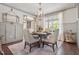 Charming dining room featuring a chandelier, wainscoting, and hardwood floors with seating for four at 110 White Oak Trl, Cumming, GA 30028