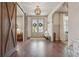Elegant entryway with hardwood floors, decorative sliding barn door, and charming decor at 110 White Oak Trl, Cumming, GA 30028