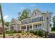 Charming two-story home with a welcoming front porch, beautiful landscaping, and classic architectural details at 110 White Oak Trl, Cumming, GA 30028