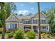 Beautiful two-story home with a covered porch, manicured landscaping, and mature trees at 110 White Oak Trl, Cumming, GA 30028