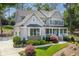 Beautiful two-story home with a covered porch, manicured landscaping, and mature trees at 110 White Oak Trl, Cumming, GA 30028