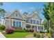 Beautiful two-story home with a covered porch, manicured landscaping, and mature trees at 110 White Oak Trl, Cumming, GA 30028