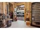 The doorway to a home gym and wine room; featuring exposed wood ceiling and modern equipment at 110 White Oak Trl, Cumming, GA 30028