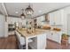 Bright kitchen with white cabinets, a granite island, and stainless steel appliances at 110 White Oak Trl, Cumming, GA 30028