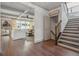 Open-concept living space with hardwood floors, stairs, and lots of natural light at 110 White Oak Trl, Cumming, GA 30028