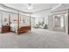 Large main bedroom boasts a tray ceiling, sitting area, and expansive carpeted floor at 110 White Oak Trl, Cumming, GA 30028
