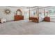 Spacious main bedroom featuring a four-poster bed, dresser, and tray ceiling at 110 White Oak Trl, Cumming, GA 30028